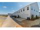 Row of new townhomes with driveways and attached garages in a community setting at 1703 Prospect Way, Conyers, GA 30094