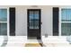 Inviting front door with glass panels flanked by windows and classic black shutters at 1703 Prospect Way, Conyers, GA 30094