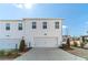 Exterior view of a white two-story home with a two-car garage and private driveway at 1703 Prospect Way, Conyers, GA 30094