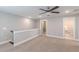 Open hallway featuring plush carpet and white trim, leading to a bathroom and other rooms at 1703 Prospect Way, Conyers, GA 30094