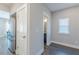 Hallway with stainless steel refrigerator and a glimpse into the powder room at 1703 Prospect Way, Conyers, GA 30094