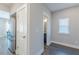 Hallway featuring a refrigerator and access to a bathroom, all adorned with neutral paint and trim at 1703 Prospect Way, Conyers, GA 30094