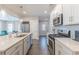 Bright, modern kitchen featuring stainless steel appliances and sleek countertops at 1703 Prospect Way, Conyers, GA 30094