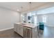 Open kitchen layout features stainless steel appliances, island with seating, and flows into the living area at 1703 Prospect Way, Conyers, GA 30094