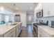 Bright kitchen with stainless steel appliances, island, white cabinetry, and open layout at 1703 Prospect Way, Conyers, GA 30094