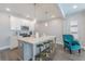 Bright kitchen with white cabinets, stainless steel appliances, and a large center island with barstool seating at 1703 Prospect Way, Conyers, GA 30094