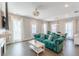 Sun-drenched living room with hardwood floors, modern furniture, and elegant dining area at 1703 Prospect Way, Conyers, GA 30094