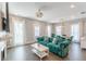 Inviting living room with a teal sofa, fireplace, dining area, and lots of natural light at 1703 Prospect Way, Conyers, GA 30094