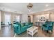 Beautiful living room with stylish turquoise sofa and elegant dining set at 1703 Prospect Way, Conyers, GA 30094