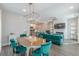 Open-concept living space featuring a dining area, kitchen, fireplace, and a comfortable velvet sofa at 1703 Prospect Way, Conyers, GA 30094