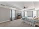 This spacious main bedroom features large windows with sheer curtains, neutral walls, and carpet at 1703 Prospect Way, Conyers, GA 30094