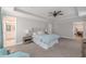 Spacious main bedroom featuring tray ceilings, ceiling fan, and ensuite bathroom at 1703 Prospect Way, Conyers, GA 30094