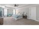 Spacious main bedroom with coffered ceiling, plush carpet, and a cozy sitting area with abundant natural light at 1703 Prospect Way, Conyers, GA 30094