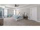 This main bedroom features a tray ceiling with recessed lights, neutral walls, carpet, and blue accents at 1703 Prospect Way, Conyers, GA 30094