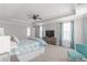 Beautiful main bedroom features large windows, soft carpet, ceiling fan and comfortable seating at 1703 Prospect Way, Conyers, GA 30094