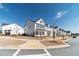Street view of a row of charming two-story homes with black shutters and white siding at 1703 Prospect Way, Conyers, GA 30094
