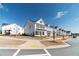 A street view shows a row of beautiful white homes in a well-planned community at 1703 Prospect Way, Conyers, GA 30094
