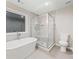 Bathroom with a standalone tub, glass shower, and sleek tiling at 3195 Tackett Rd, Douglasville, GA 30135