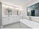 Bathroom featuring double vanity, a large window, and a modern tub at 3195 Tackett Rd, Douglasville, GA 30135
