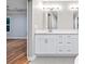 Bright bathroom featuring double vanity, a large mirror, and modern finishes at 3195 Tackett Rd, Douglasville, GA 30135