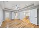 Large bedroom with hardwood floors, a ceiling fan, and multiple doors at 3195 Tackett Rd, Douglasville, GA 30135