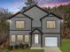 Charming two-story home with gray siding, black trim, white garage door, and a well-manicured lawn at 3195 Tackett Rd, Douglasville, GA 30135