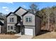 Stylish two-story home with a single car garage, gray siding, black trim, and a well-maintained lawn at 3195 Tackett Rd, Douglasville, GA 30135