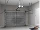 Interior view of the garage with automatic door and ample space at 3195 Tackett Rd, Douglasville, GA 30135