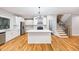 Kitchen with island, white cabinets, stainless appliances, and hardwood flooring at 3195 Tackett Rd, Douglasville, GA 30135