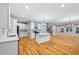 Open concept kitchen with white cabinets, island, stainless appliances and hardwood floors at 3195 Tackett Rd, Douglasville, GA 30135