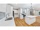 Bright kitchen featuring white cabinets, stainless steel appliances, hardwood floors and a center island at 3195 Tackett Rd, Douglasville, GA 30135