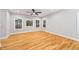 Bright, open living room featuring hardwood floors, ceiling fan, and large windows at 3195 Tackett Rd, Douglasville, GA 30135