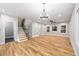 Living room featuring hardwood floors, staircase, and contemporary lighting at 3195 Tackett Rd, Douglasville, GA 30135