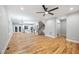 Living room with beautiful hardwood floors, ceiling fan, stairs, and white trim at 3195 Tackett Rd, Douglasville, GA 30135