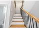 Wooden staircase featuring iron spindles and a handrail at 3195 Tackett Rd, Douglasville, GA 30135