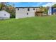 Wide backyard featuring lush lawn, and a modern two-story house with a deck at 3850 Crosby Nw Dr, Atlanta, GA 30331
