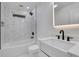 Modern bathroom with a sleek vanity, stylish fixtures, and pristine white tiles at 3850 Crosby Nw Dr, Atlanta, GA 30331