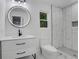 Bright bathroom featuring a sleek vanity, a modern mirror, and a walk-in shower at 3850 Crosby Nw Dr, Atlanta, GA 30331