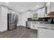 Bright kitchen featuring stainless steel appliances, granite countertops, and stylish white cabinetry at 3850 Crosby Nw Dr, Atlanta, GA 30331