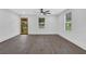 Sunlit living space featuring wood-look floors, white walls and a modern front door with glass panels at 3850 Crosby Nw Dr, Atlanta, GA 30331
