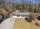 Aerial view of the home with a driveway and landscaped front yard and solar panels at 147 Windy Hill Sw Rd, Marietta, GA 30060