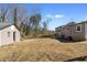 Exterior view of backyard with shed, grass area, and partially fenced yard on a sunny day at 147 Windy Hill Sw Rd, Marietta, GA 30060