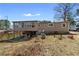 View of the back of the house showing the outdoor back porch with a fenced in backyard and a white SUV at 147 Windy Hill Sw Rd, Marietta, GA 30060