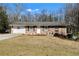 Inviting brick home with attached garage, complemented by a spacious front yard and cozy landscaping at 147 Windy Hill Sw Rd, Marietta, GA 30060