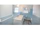 Bathroom with a bright window, and blue tiled walls, featuring a sink and vanity at 3894 Summit Dr, Douglasville, GA 30135