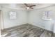 Bedroom with light green walls, gray wood grain flooring, and natural light at 3894 Summit Dr, Douglasville, GA 30135