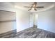 Bedroom with gray wood-look flooring, a ceiling fan, and a closet with built in shelves at 3894 Summit Dr, Douglasville, GA 30135