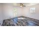 This bright bedroom features modern grey flooring and two large windows at 3894 Summit Dr, Douglasville, GA 30135