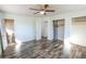 Spacious bedroom with light green walls, ceiling fan and gray wood grain flooring at 3894 Summit Dr, Douglasville, GA 30135