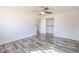 White walled bedroom featuring gray wood grain flooring, ceiling fan, and closet at 3894 Summit Dr, Douglasville, GA 30135